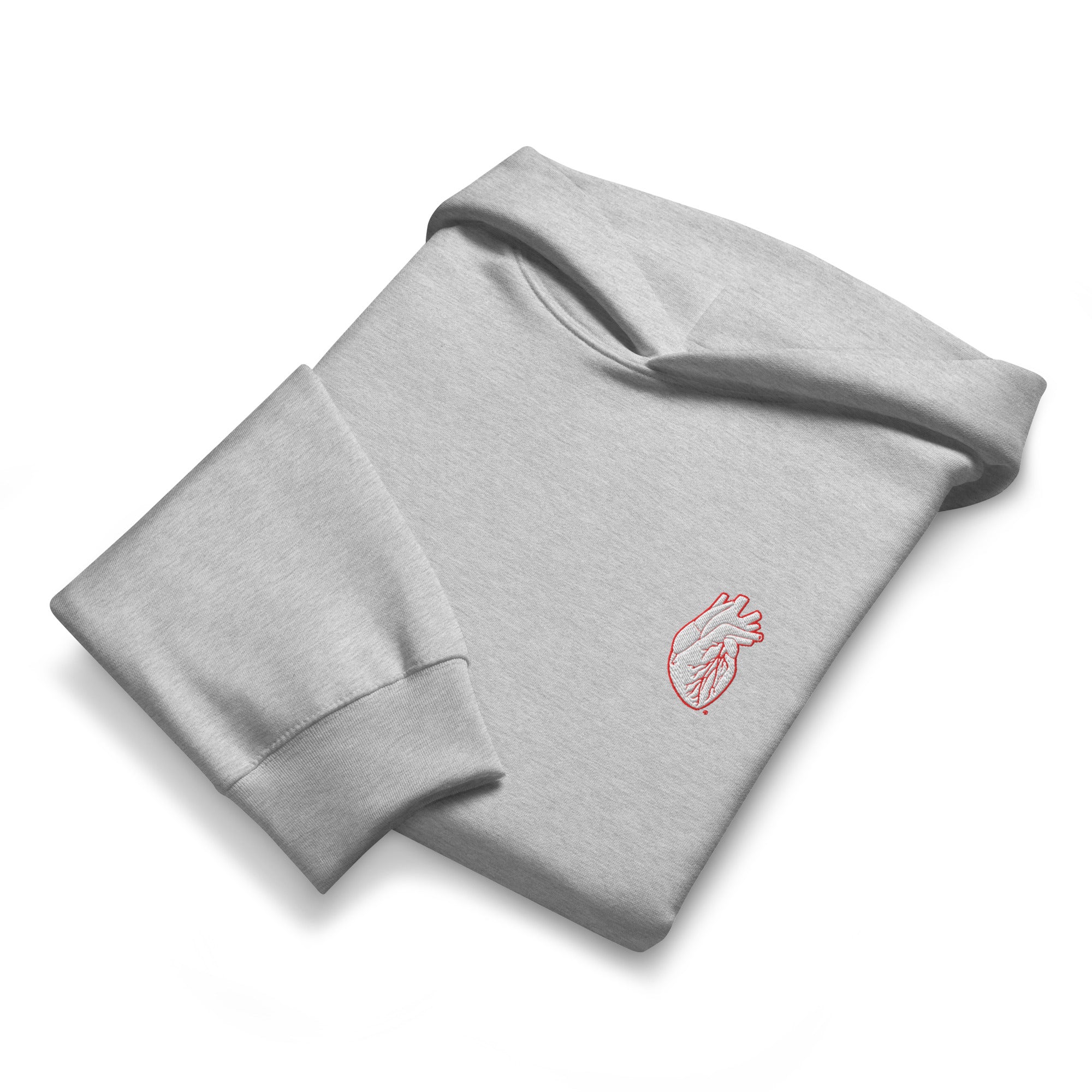 Folded gray sweatshirt with a red heart design on a white background